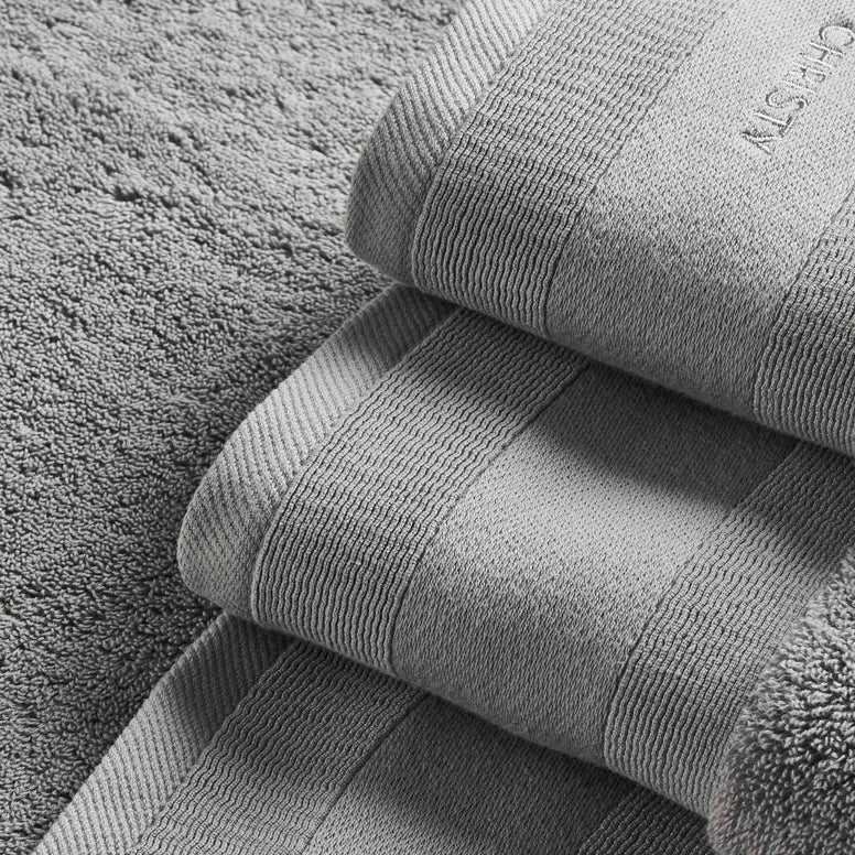 Stack of gray towels on a textured surface
