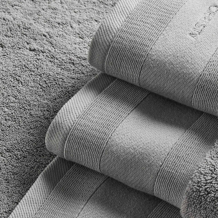 Stack of gray towels on a textured surface