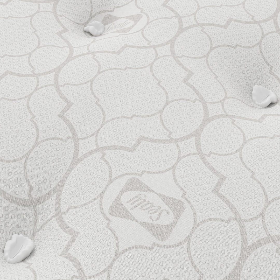 Close-up of a mattress with a Sealy logo.