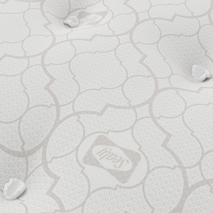 Close-up of a mattress with a Sealy logo.