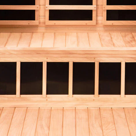 Wooden sauna interior with bench and glass panels