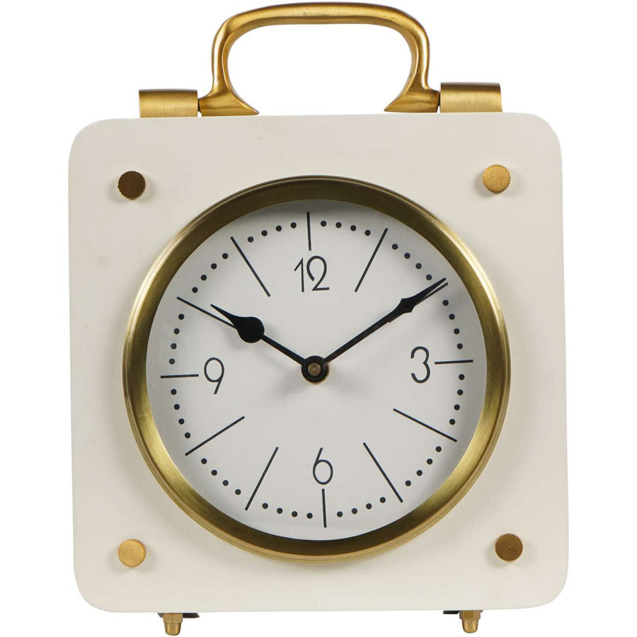Small clock with gold frame and handle on a white background