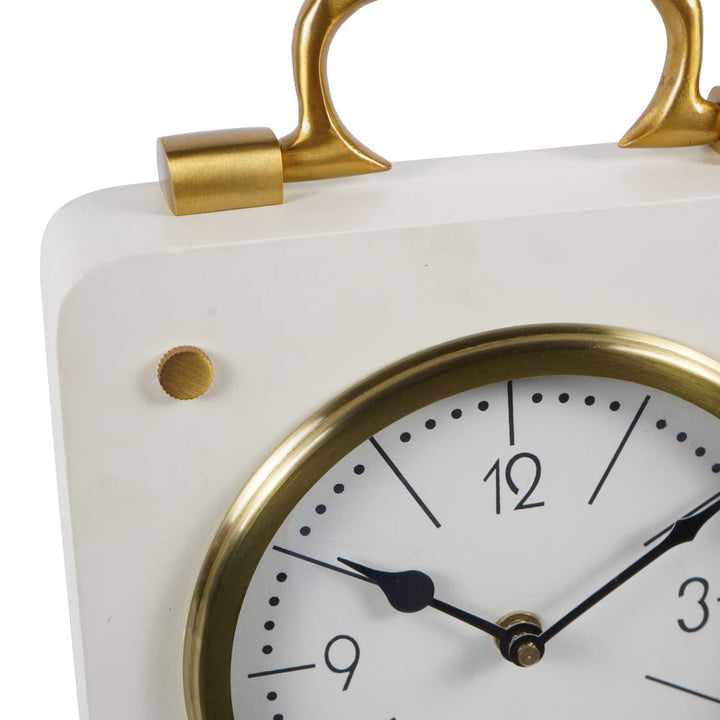 White clock with gold accents on a white background