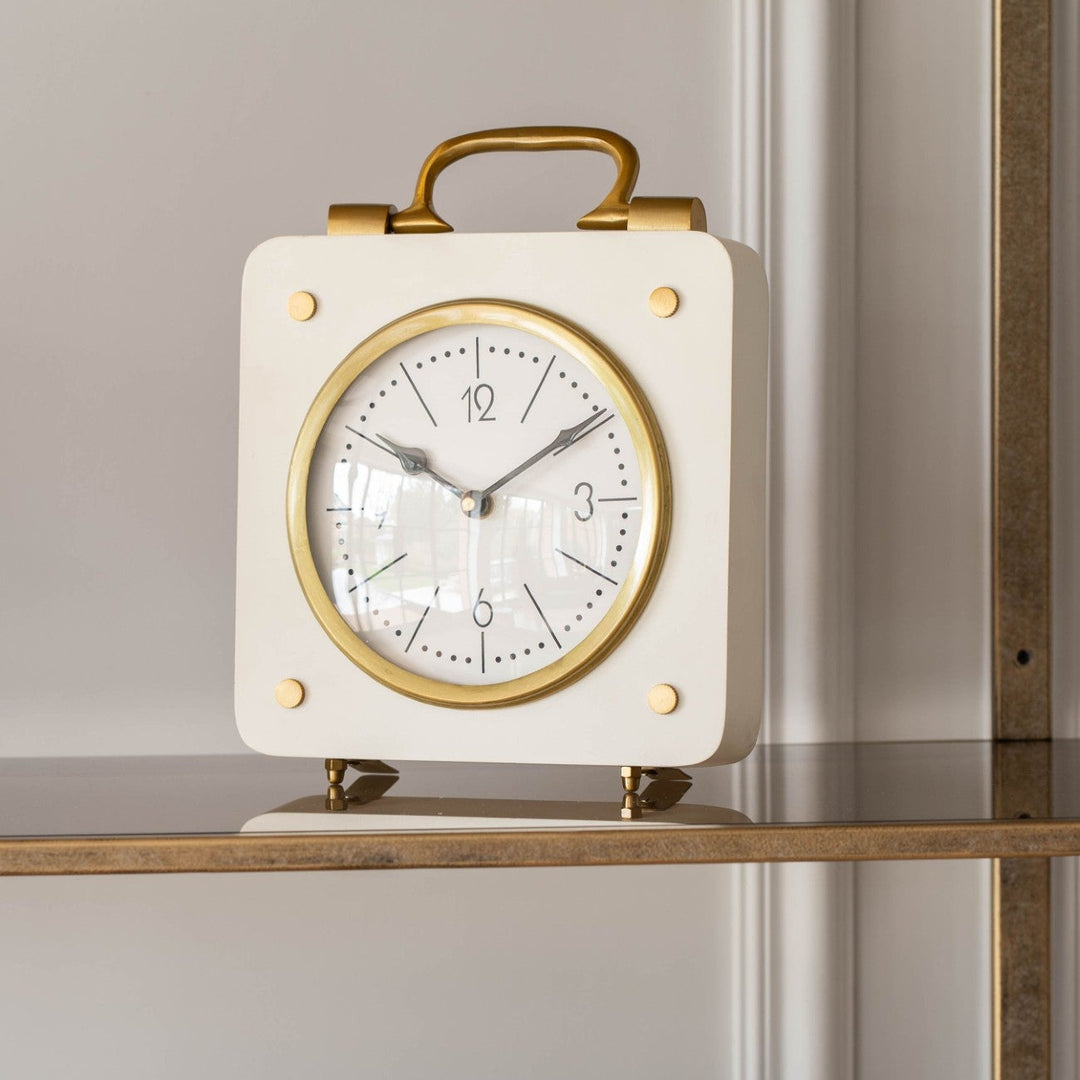 Decorative clock with gold accents on a shelf