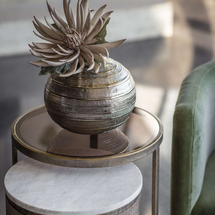Decorative plant in a textured pot on a marble table