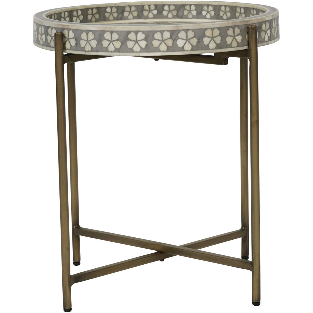 Small round table with floral patterned top on a white background