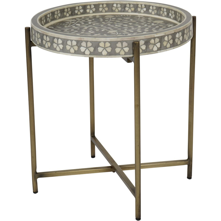 Round side table with floral patterned top on a white background