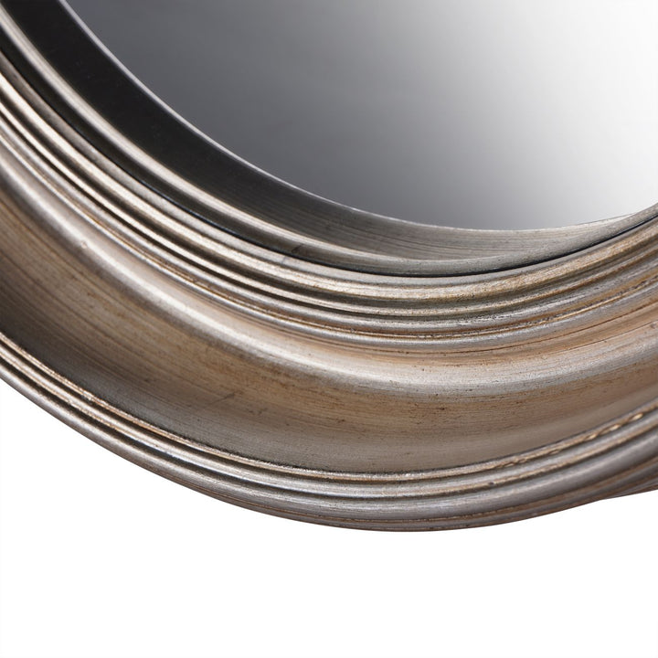 Round mirror with a metallic frame on a white background