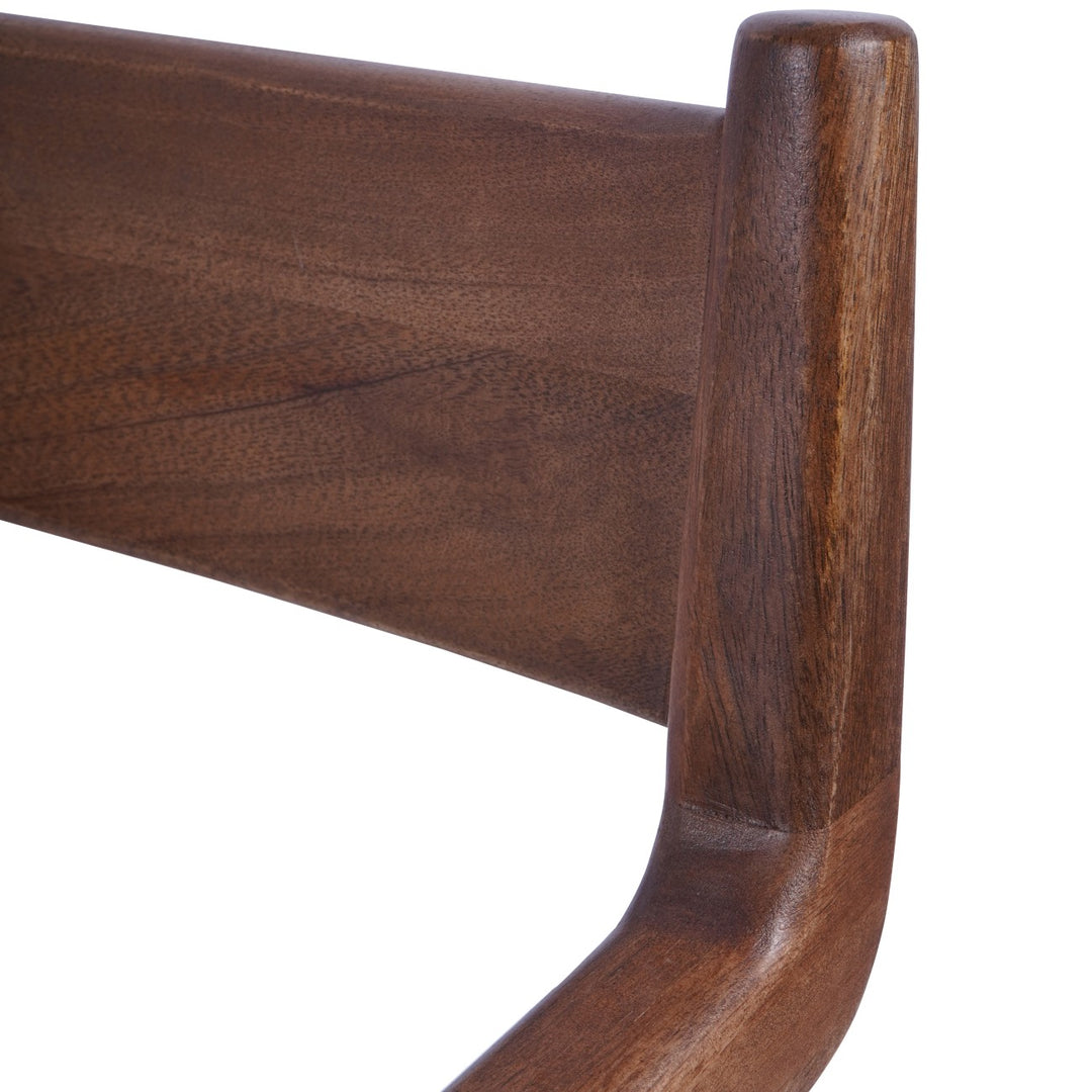 Close-up of a wooden chair arm on a white background