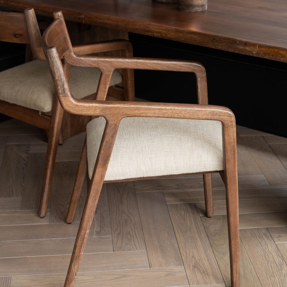 Wooden chair with beige cushion in a dining setting