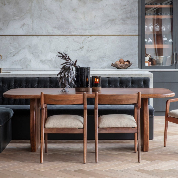 Dining area with wooden table and chairs in a modern kitchen setting.