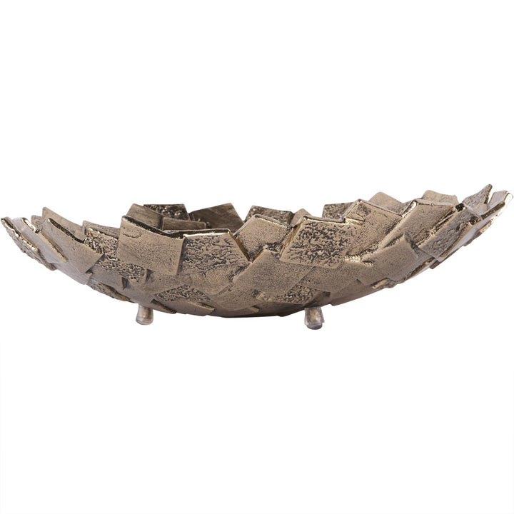 Decorative metal bowl with textured surface on a white background