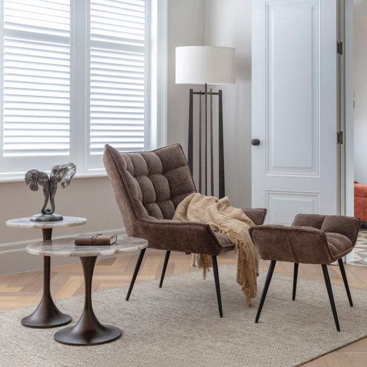 Modern living room with brown armchair, side table, and rug.
