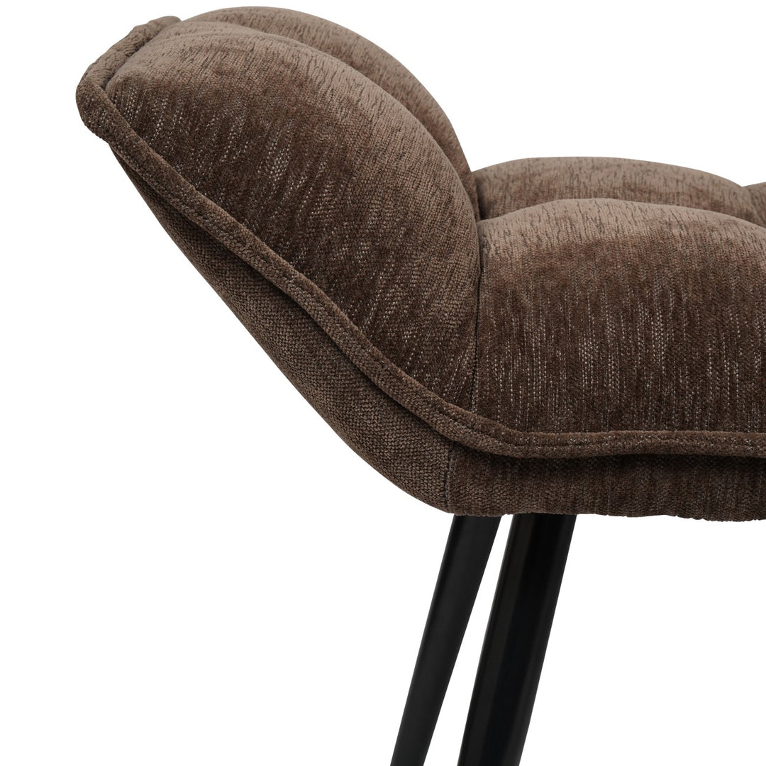 Brown upholstered chair with black legs on a white background