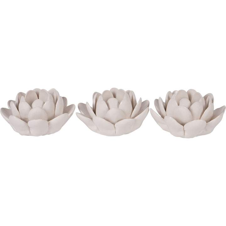 Three white ceramic lotus flower ornaments on a white background