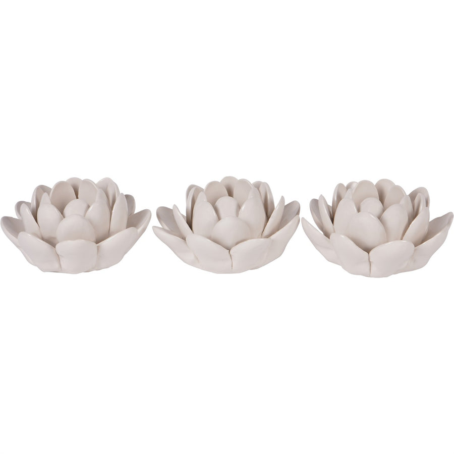 Three white ceramic lotus flower ornaments on a white background