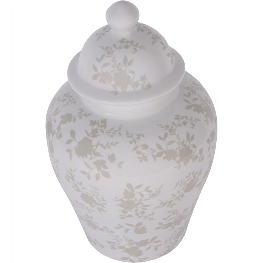 White ceramic jar with floral patterns on a white background