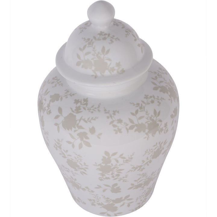 White ceramic jar with floral patterns on a white background