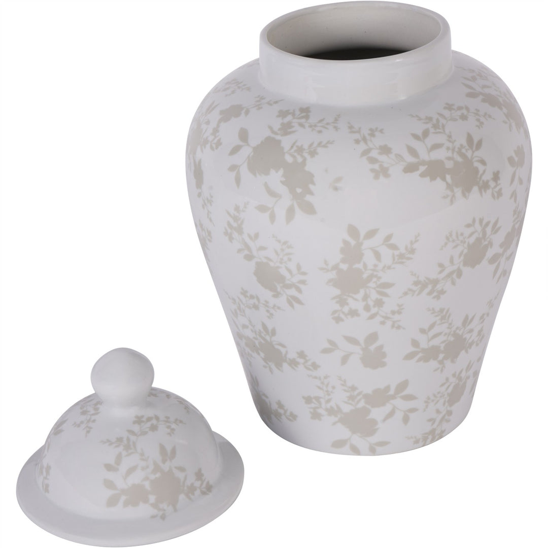 White ceramic urn with floral pattern and matching lid on a white background