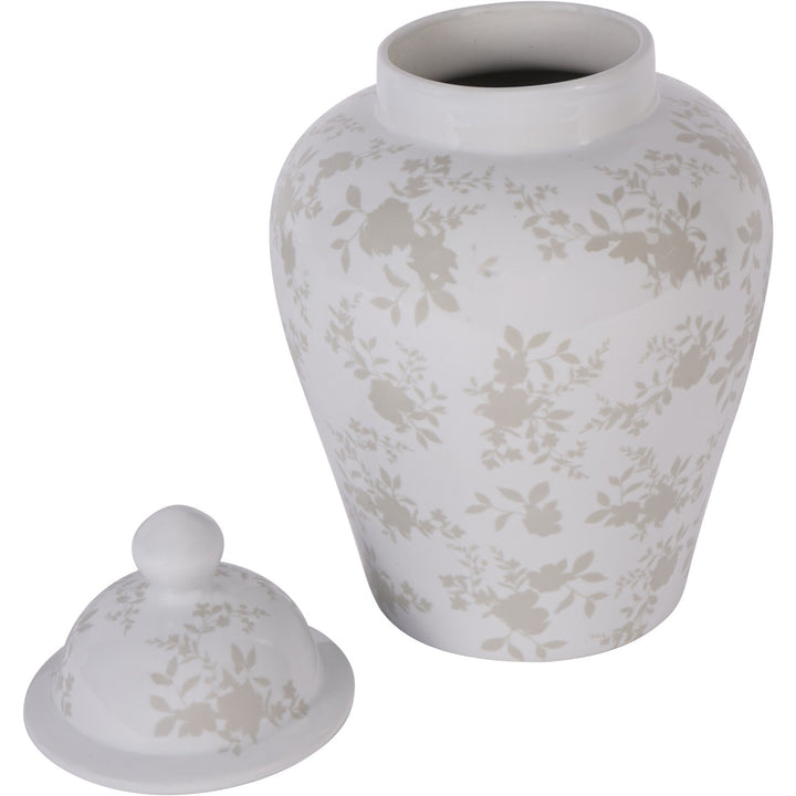 White ceramic urn with floral pattern and matching lid on a white background