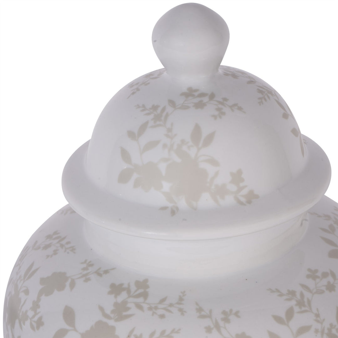 White ceramic jar with floral patterns on a white background