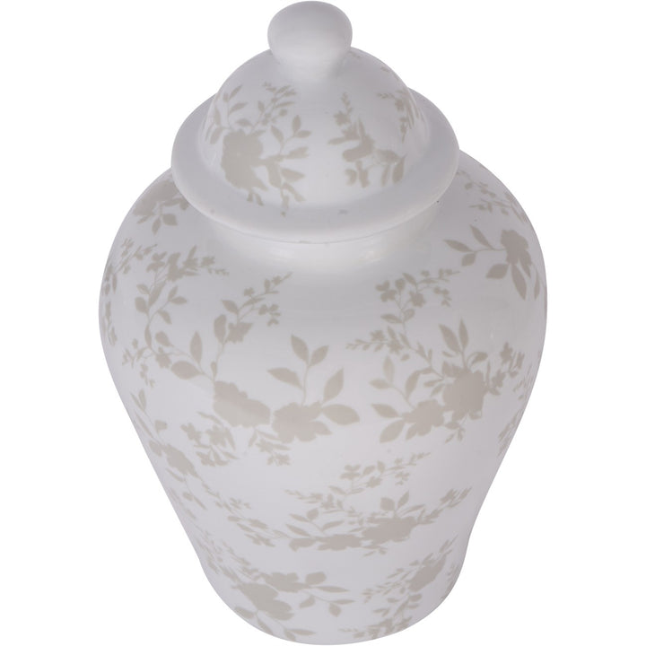 White ceramic jar with floral patterns on a white background
