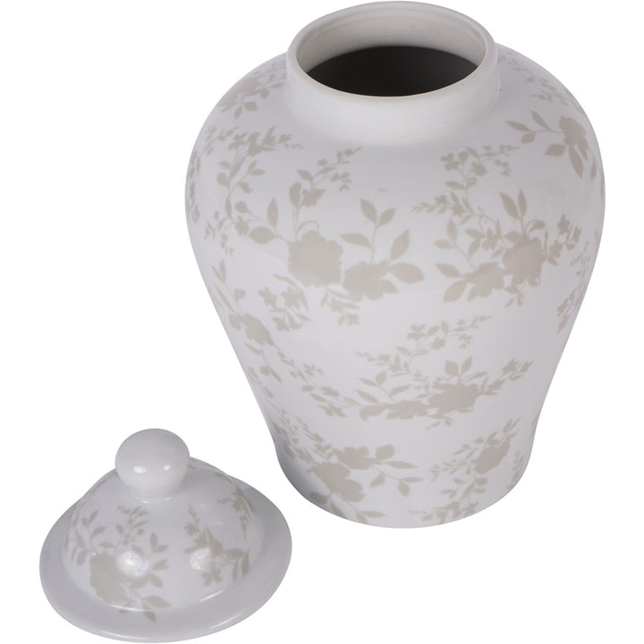 White ceramic urn with floral patterns and matching lid on a white background