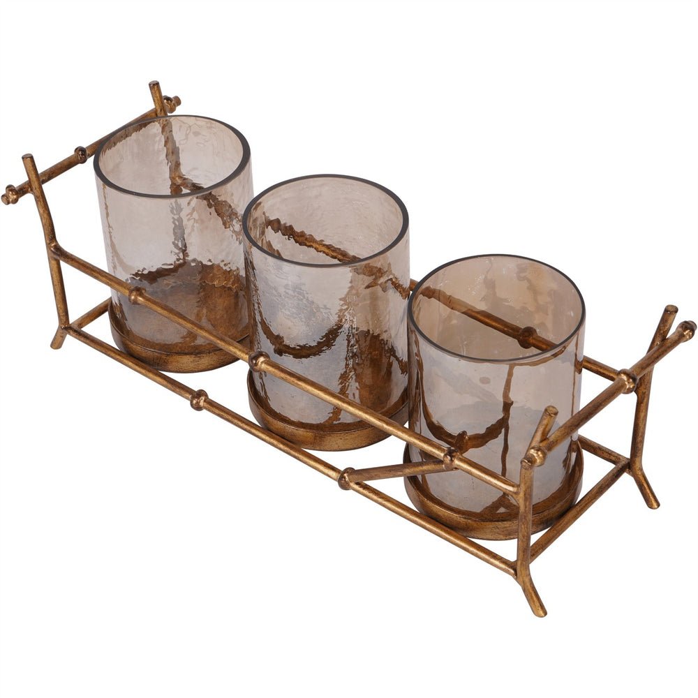 Set of three glass candle holders with a bronze metal holder on a white background