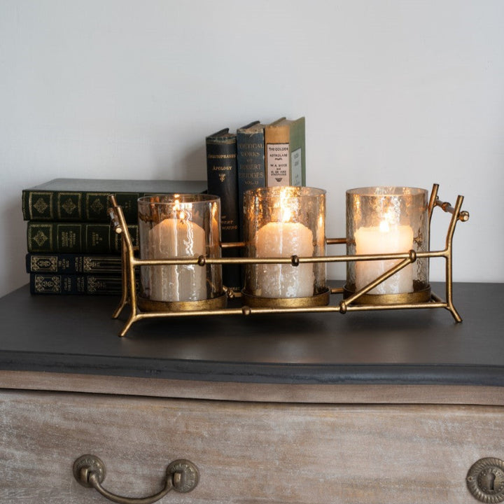 Decorative candle holder with candles on a wooden surface