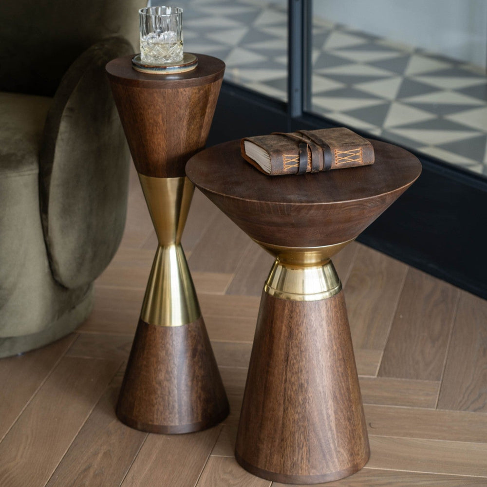 Two wooden side tables with gold accents on a wooden floor.