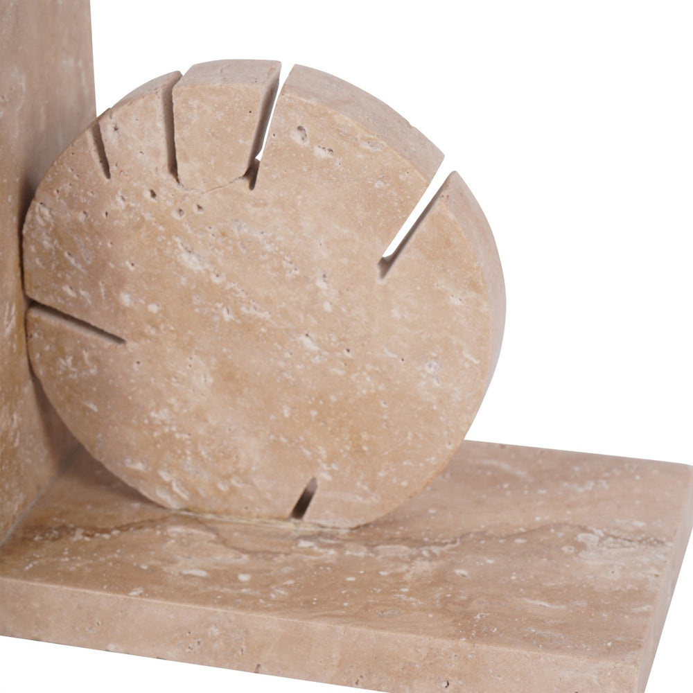 Close-up of beige stone blocks with cut-out design on a white background