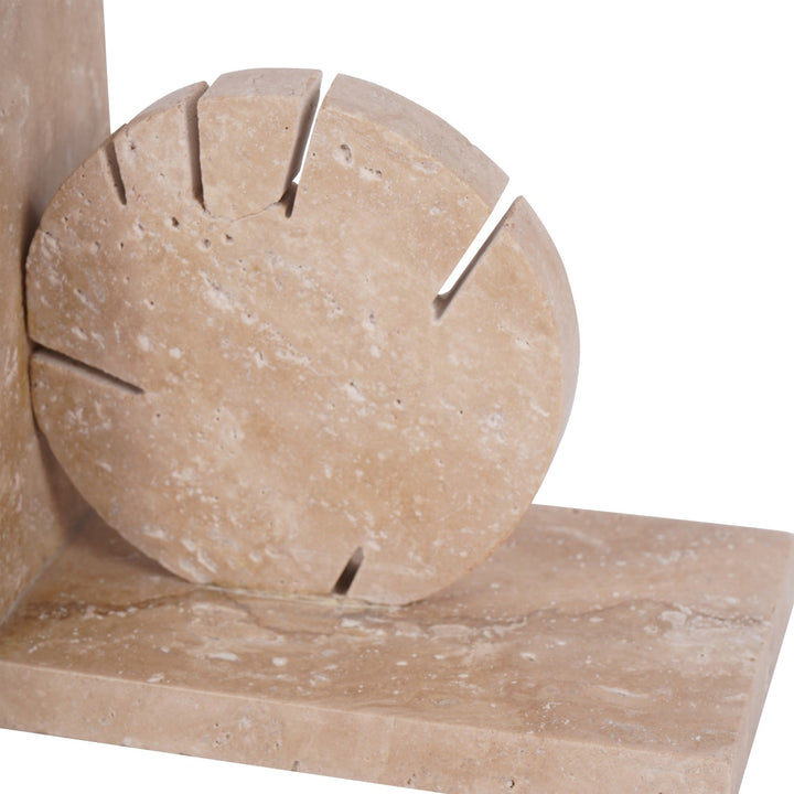 Close-up of beige stone blocks with cut-out design on a white background