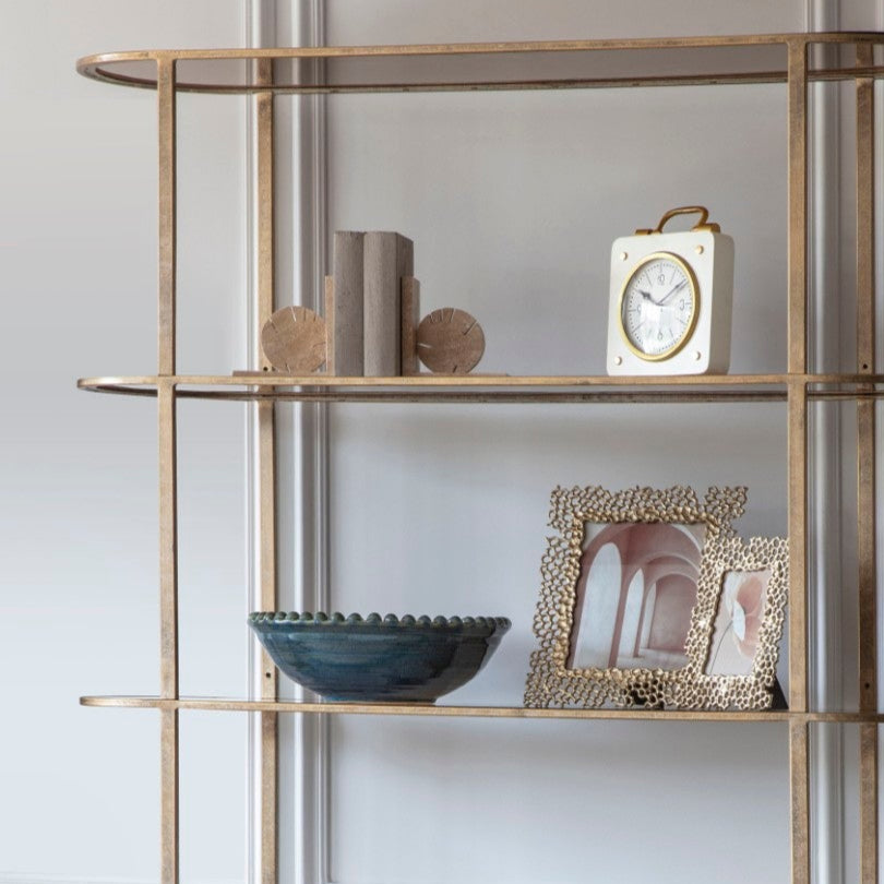 Modern interior with a stylish bookshelf and armchair.