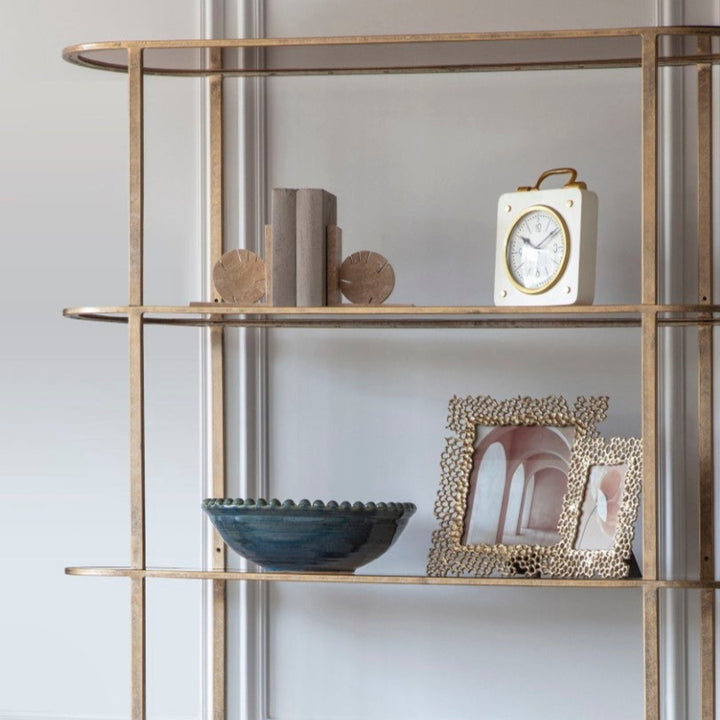 Modern interior with a stylish bookshelf and armchair.