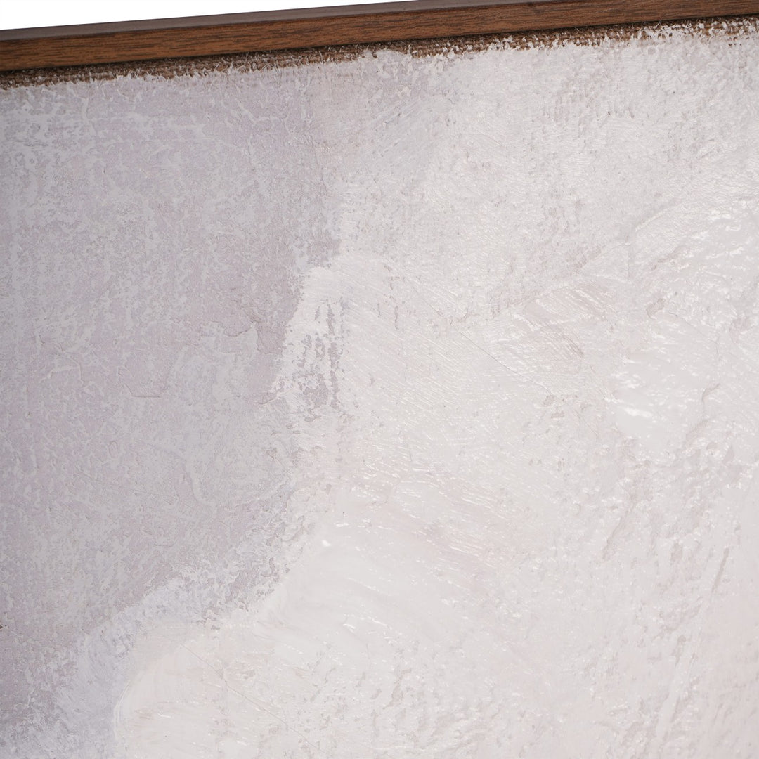 Close-up of a textured white surface with a wooden frame at the top.