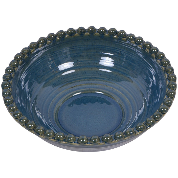 Blue ceramic bowl with green bead-like rim on a white background