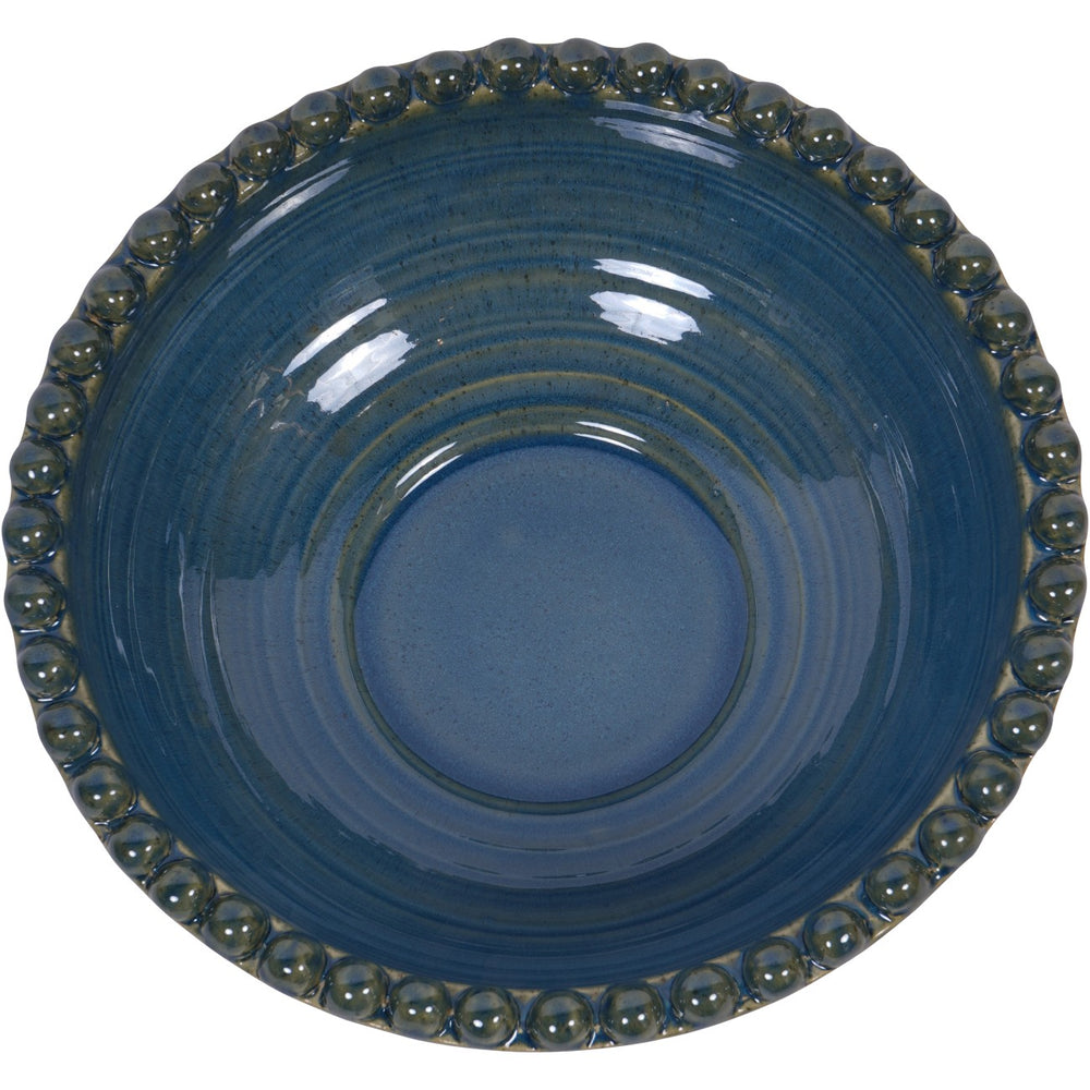 Blue ceramic bowl with decorative edge on a white background