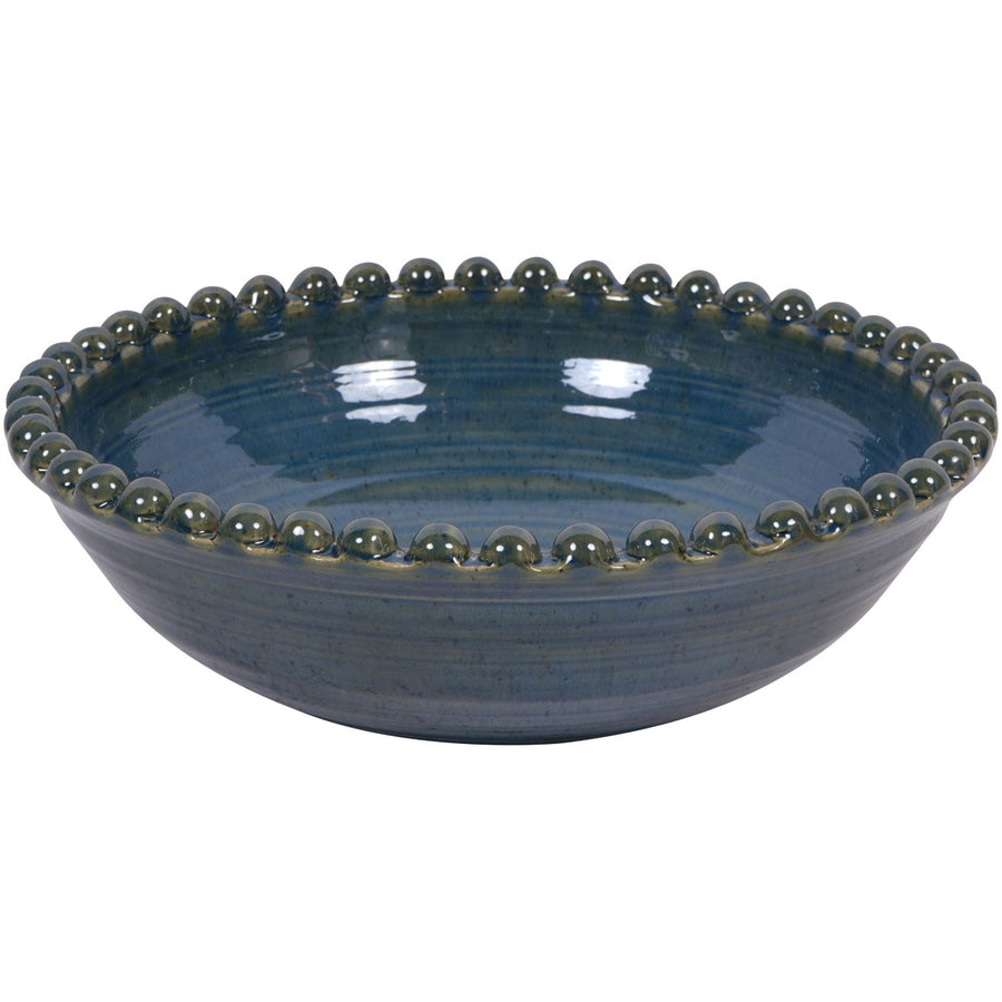 Blue ceramic bowl with decorative rim on a white background