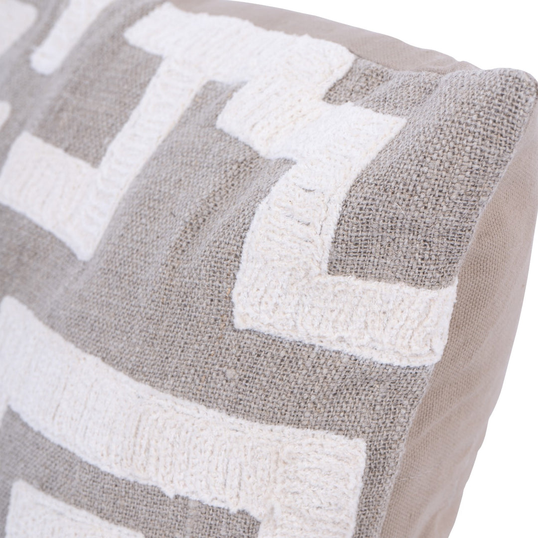 Close-up of a textured cushion with chevron pattern in grey and white.