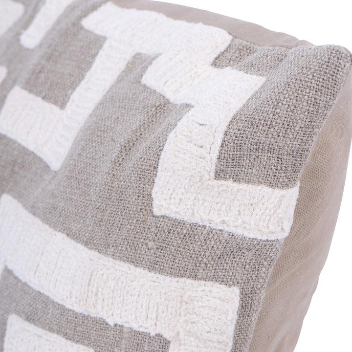 Close-up of a textured cushion with chevron pattern in grey and white.