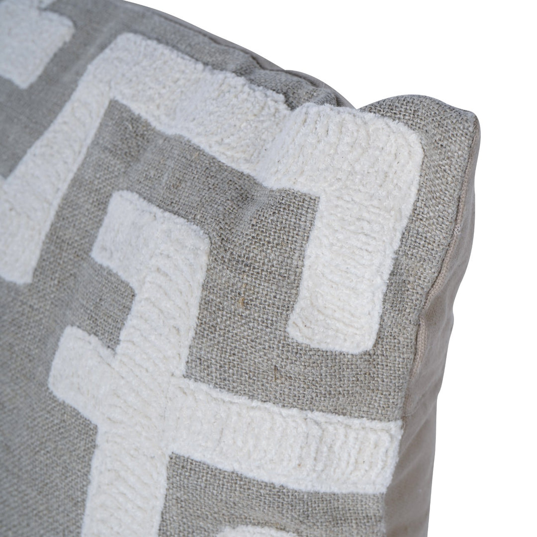 Close-up of a textured pillow with geometric pattern on a white background