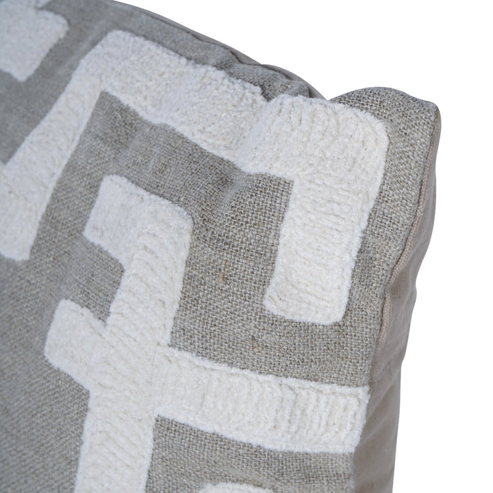 Close-up of a textured pillow with geometric pattern on a white background