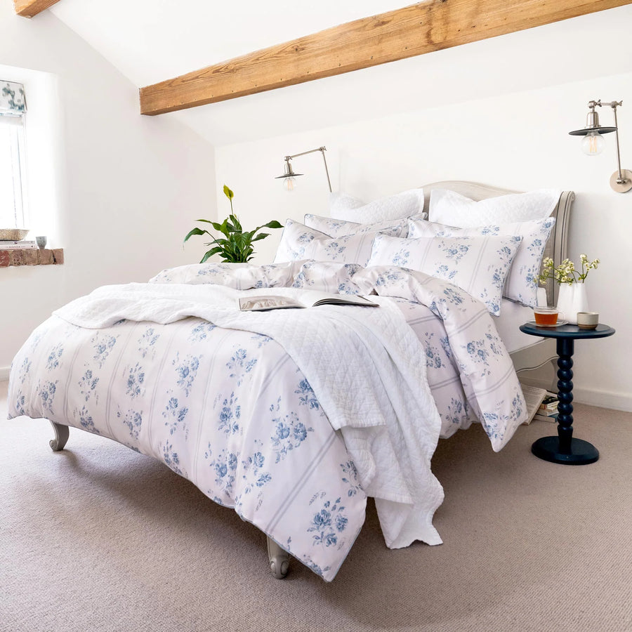 Bedroom with floral bedding and decorative elements