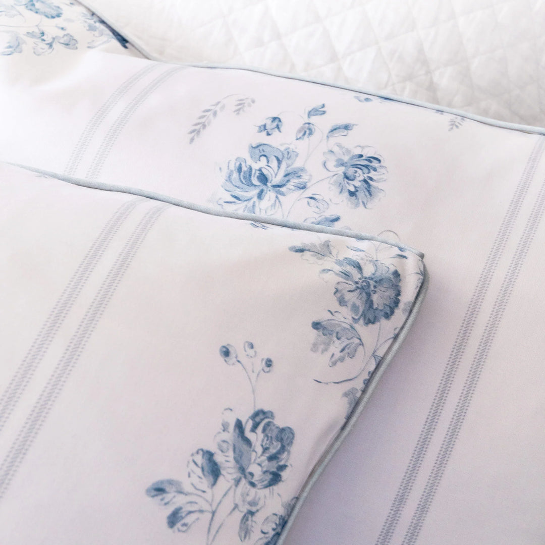 Floral-patterned bedding with blue flowers on a white background