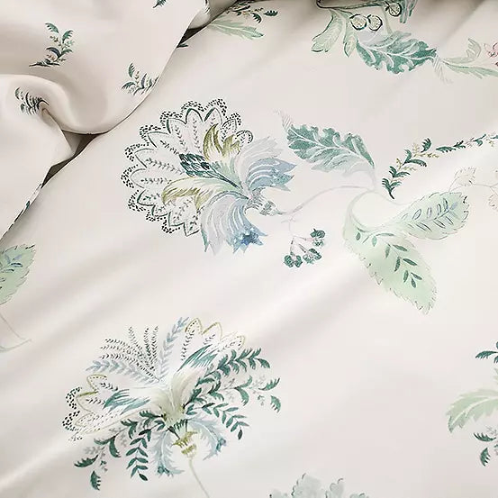 Floral patterned fabric with green leaves and flowers on a white background