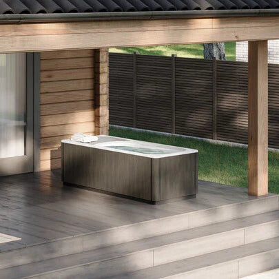 Modern outdoor cold plunge on a wooden deck with a house in the background