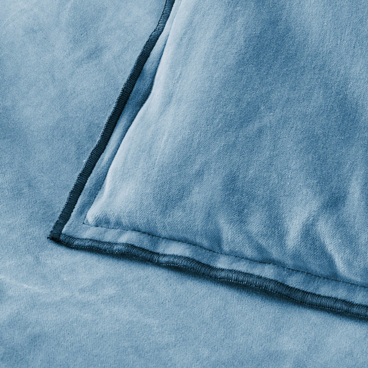 Close-up of a blue textured fabric with a folded edge