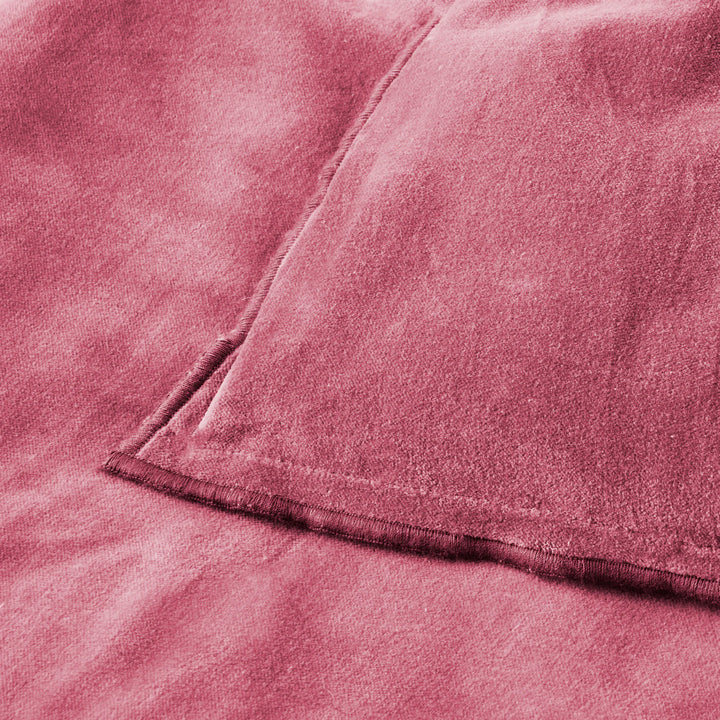 Close-up of a textured pink fabric with a folded edge