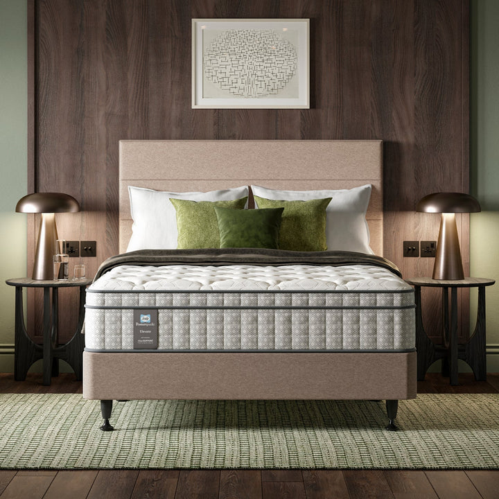 Bed with a Sealy Opulence mattress and side tables in a hotel bedroom setting