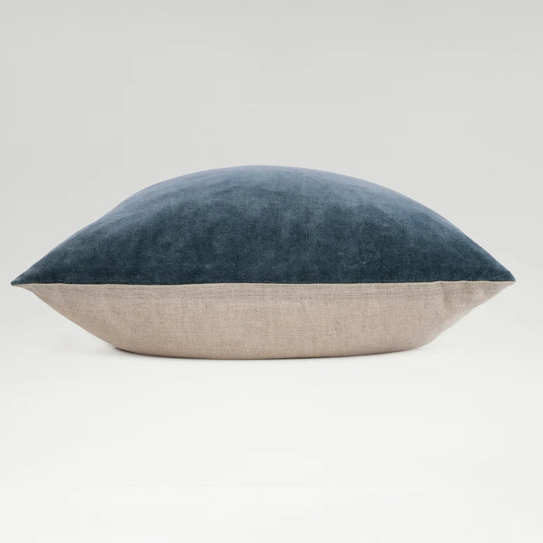 Two-toned pillow with blue top and beige bottom on a light gray background
